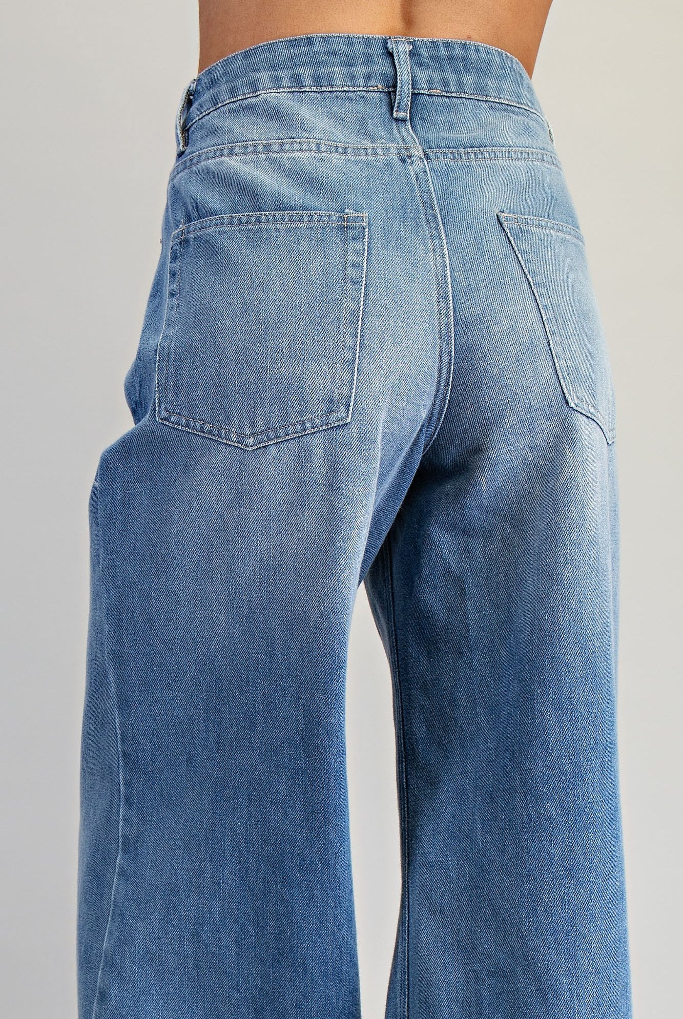 Ruffle hem wide-leg mineral washed jeans by RARA Boutique, showcasing stylish ruffle details and relaxed fit.