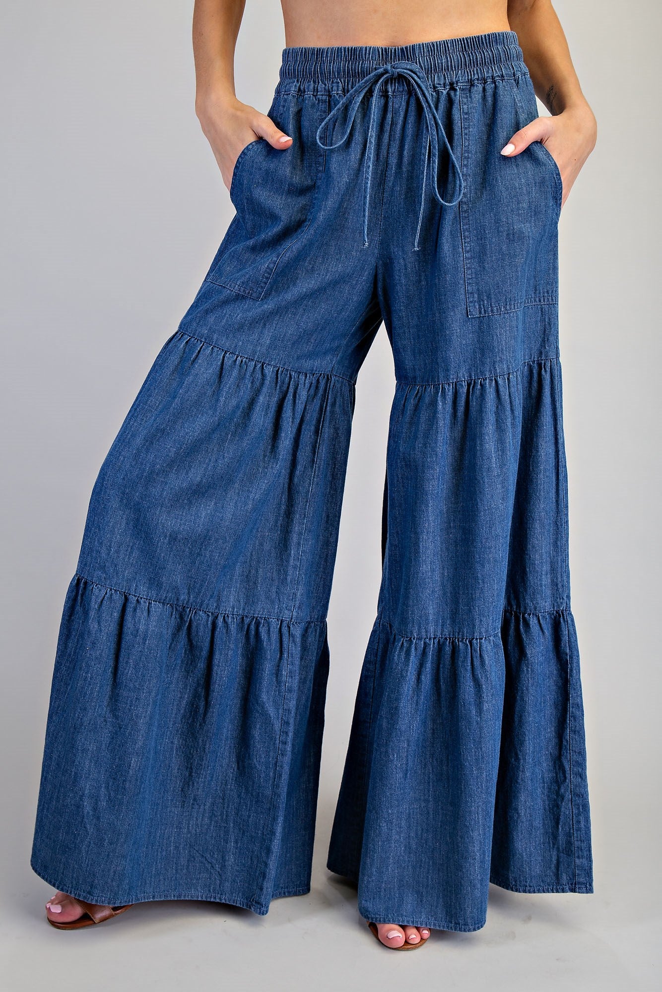 RARA Boutique mineral washed denim palazzo pants with tiered ultra-wide legs and relaxed fit, shown on a model.