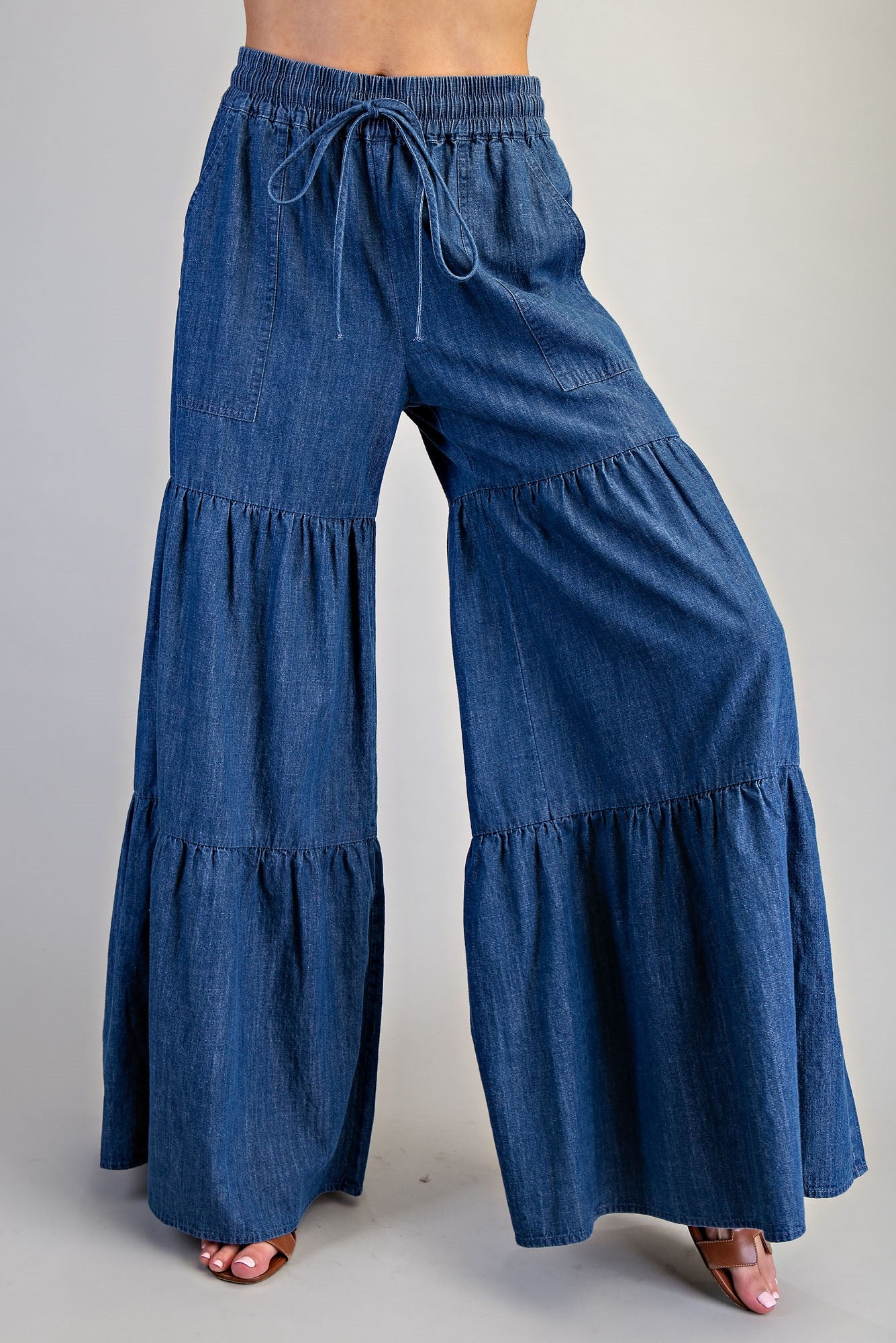 RARA Boutique mineral washed denim palazzo pants with wide, tiered ultra-wide legs and relaxed fit.