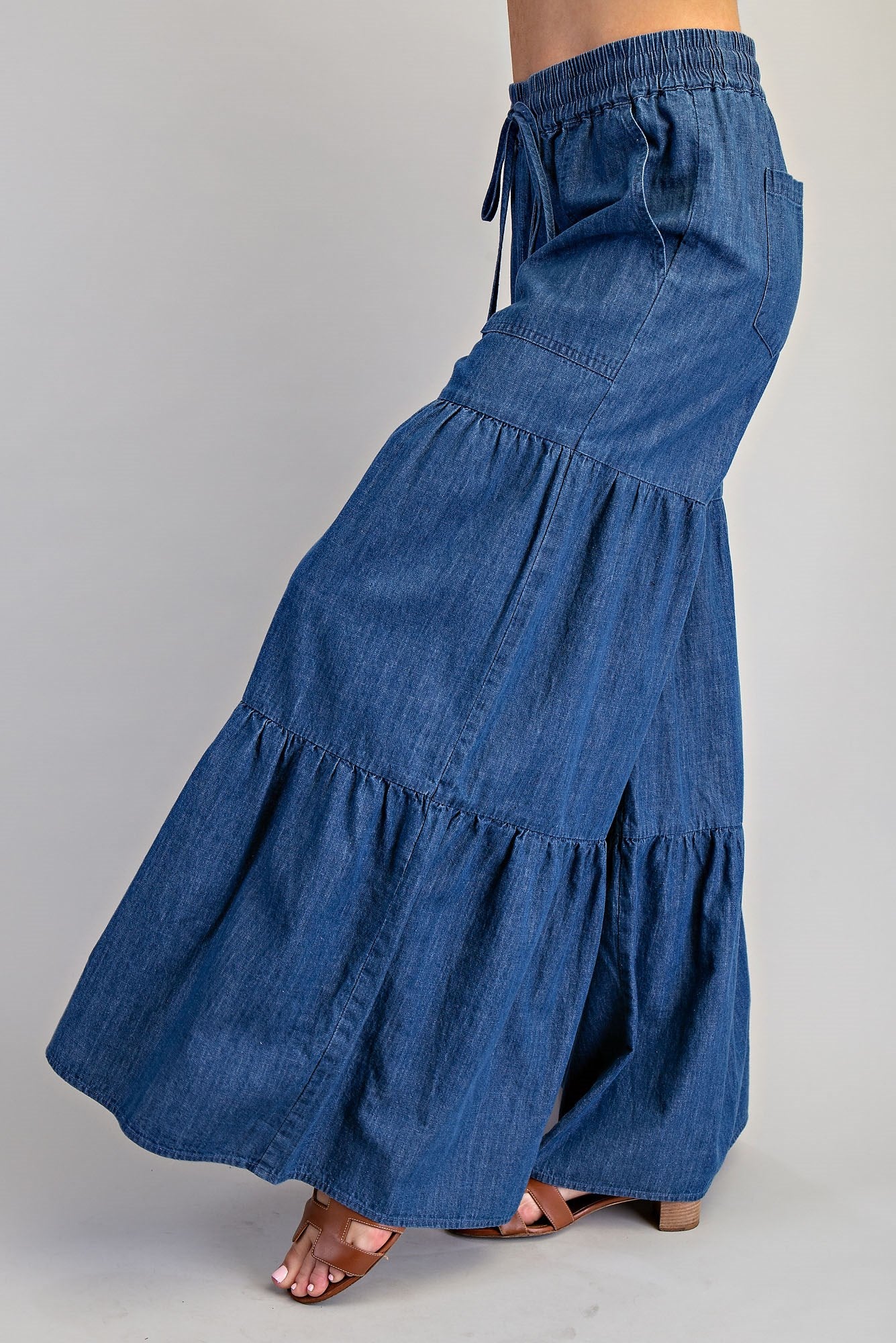 Mineral washed denim palazzo pants with tiered wide-leg design from RARA Boutique, showcasing relaxed fit and stylish silhouette.