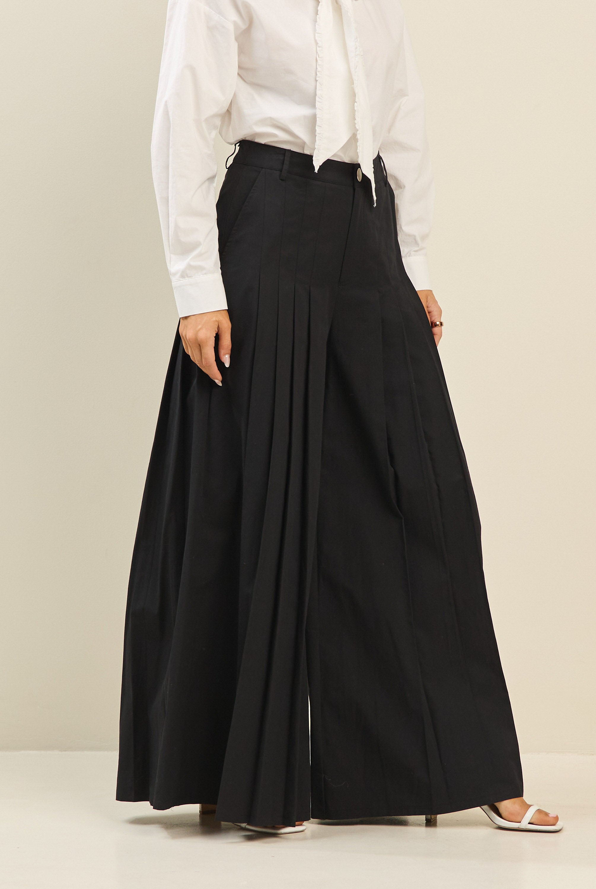 Light beige pleated ultra-wide leg cotton trousers by RARA Boutique, featuring a relaxed fit and flowing silhouette.