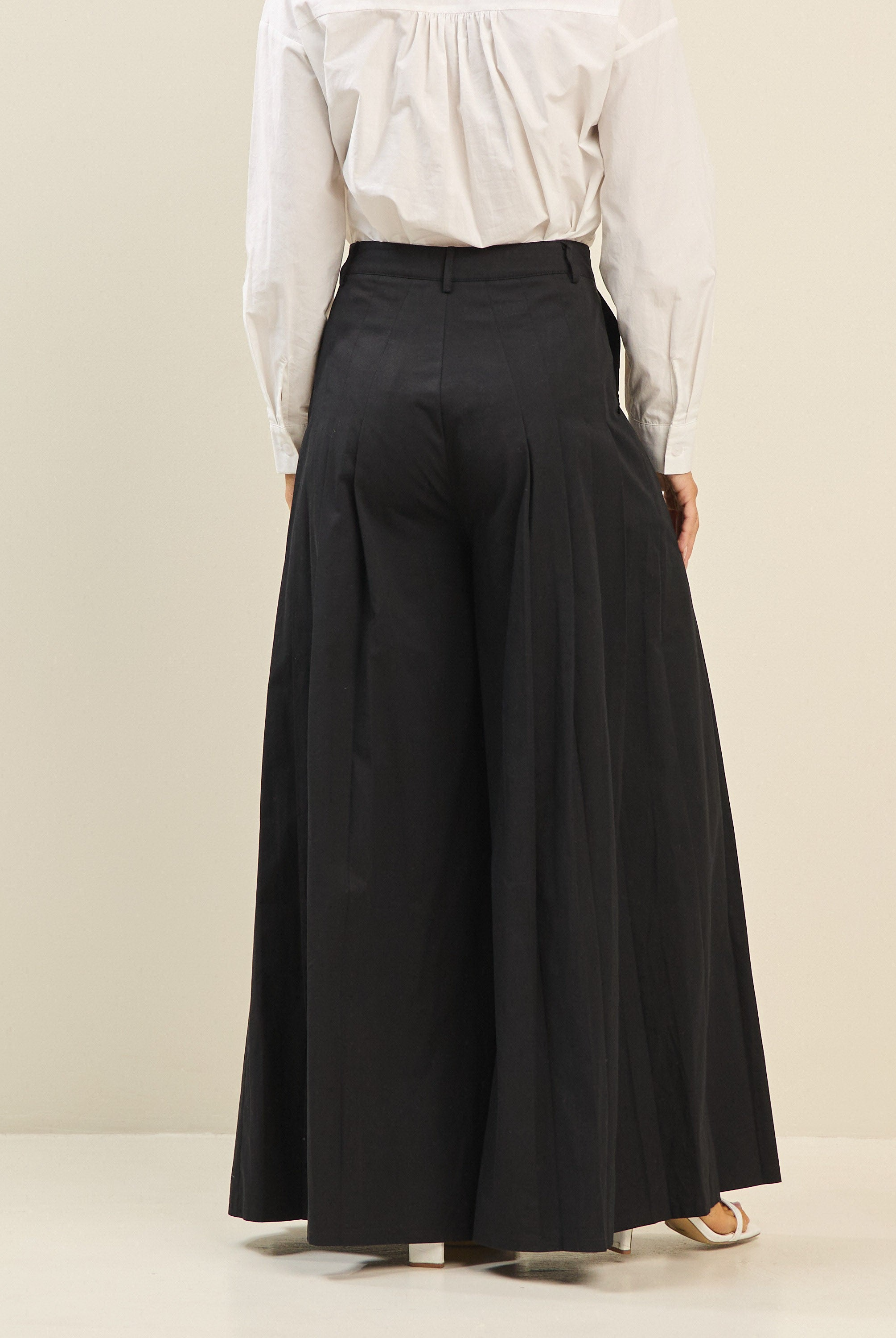 Light beige pleated ultra-wide leg cotton trousers by RARA Boutique, shown with a relaxed fit and stylish pleats.