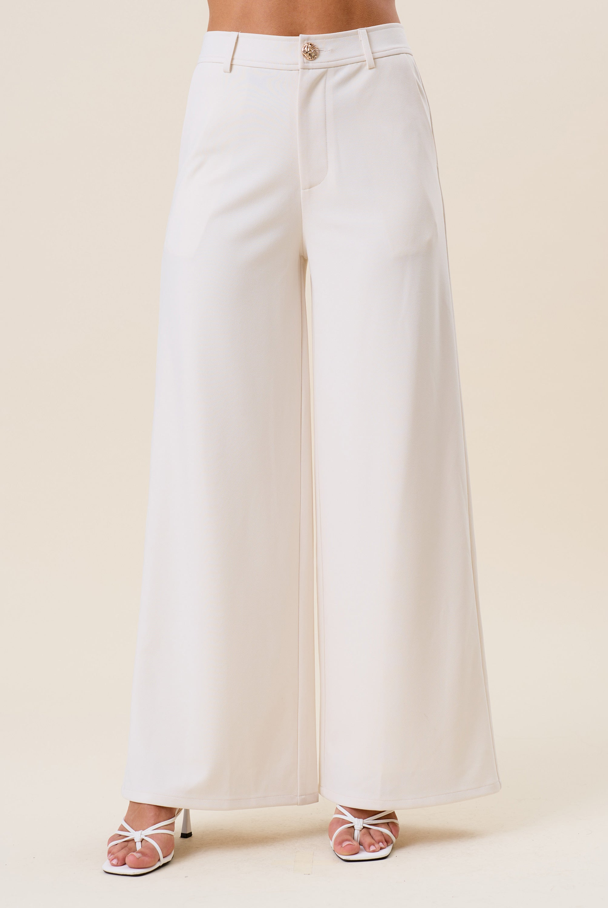 High waist tailored wide-leg trousers by RARA Boutique, featuring a sleek fit and classic design in neutral fabric.