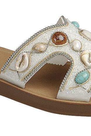 White boho H-strap slide sandals with seashell and beaded details from RARA Boutique, featuring a stylish and comfortable sandal design.