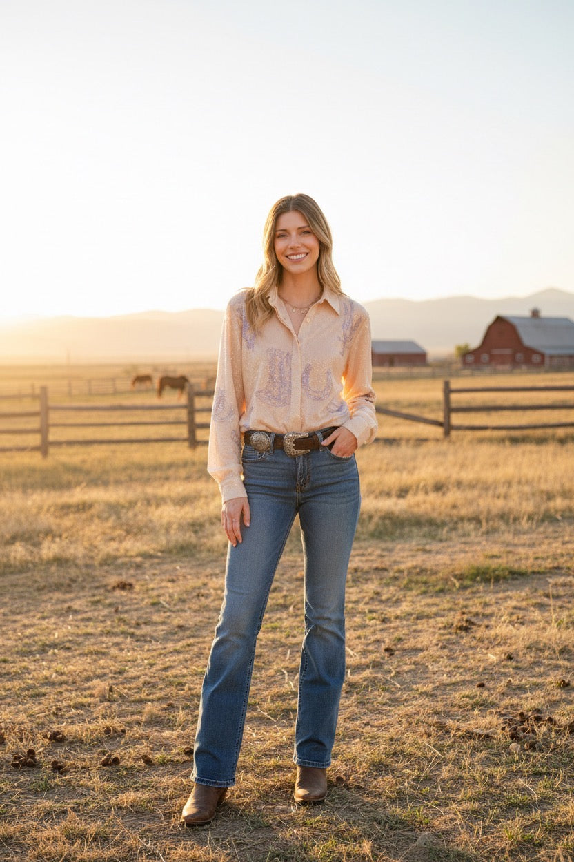 Blue Western embroidered sequin button-down shirt from RARA Boutique displayed on a hanger.