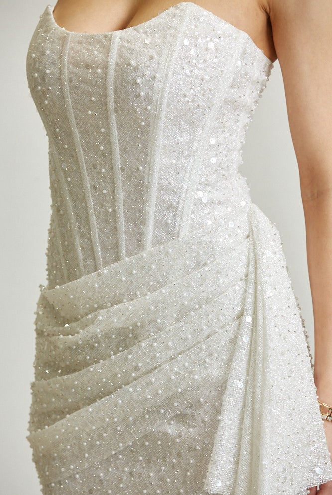 Strapless sequin glitter mesh corset mini dress with draped skirt by RARA Boutique, featuring shiny sequins and a fitted silhouette.