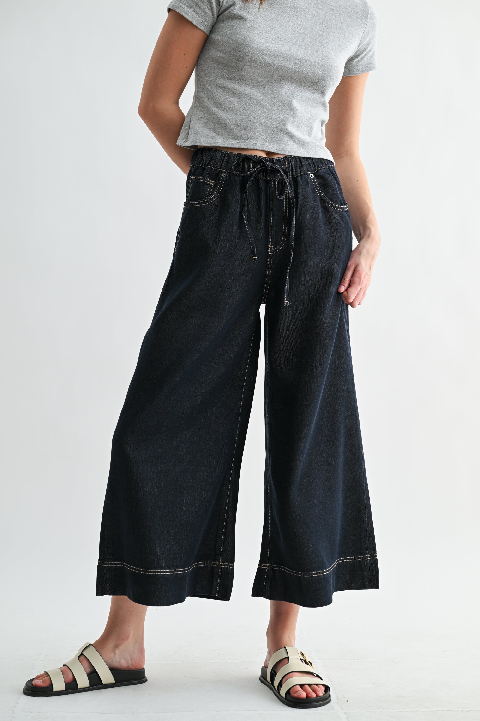 Light blue wide-leg high-rise cropped denim-look jogger pants by RARA Boutique, styled with rolled cuffs and functional pockets.