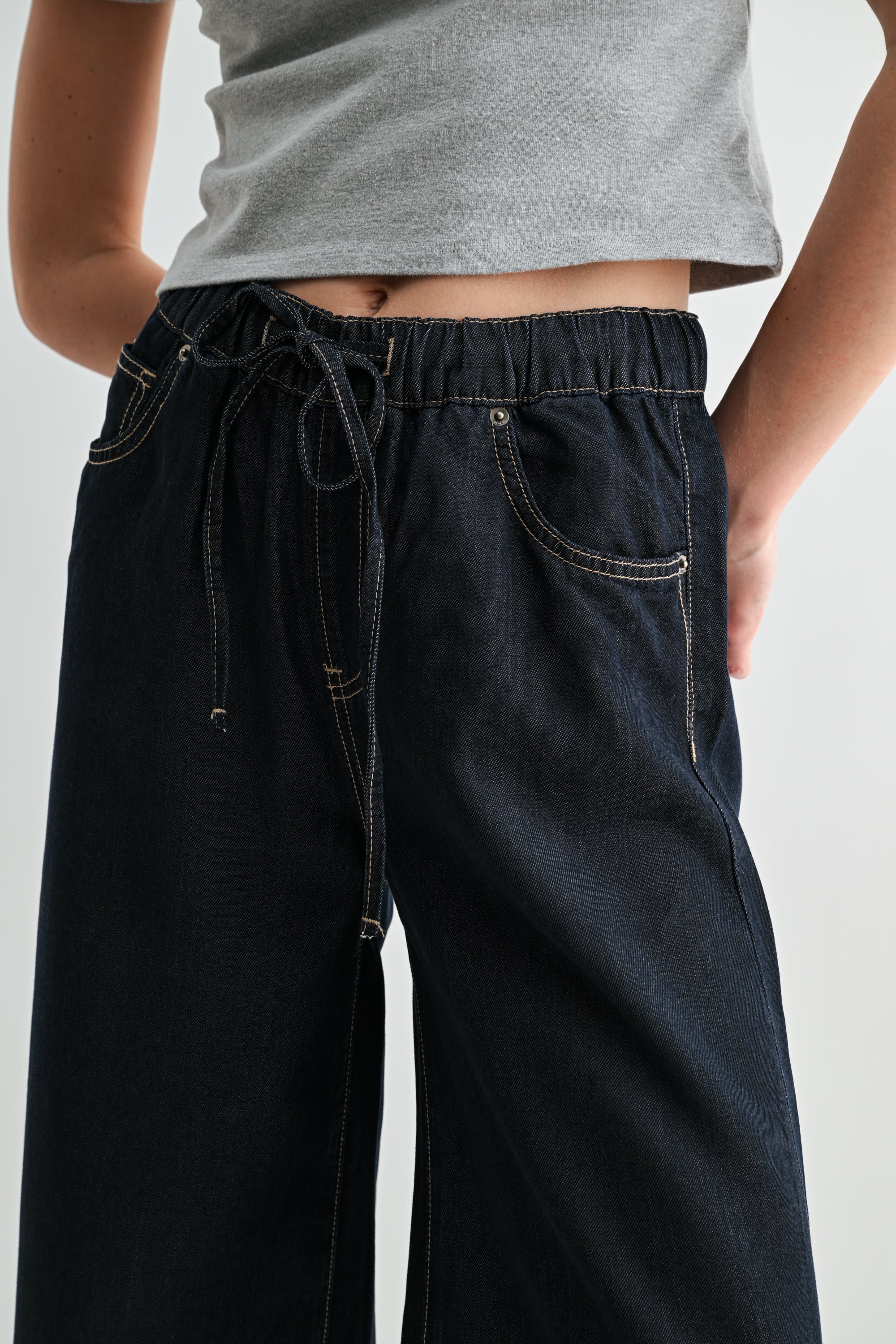 Wide leg high rise cropped denim-look jogger pants in blue from RARA Boutique, featuring a relaxed fit and casual style.