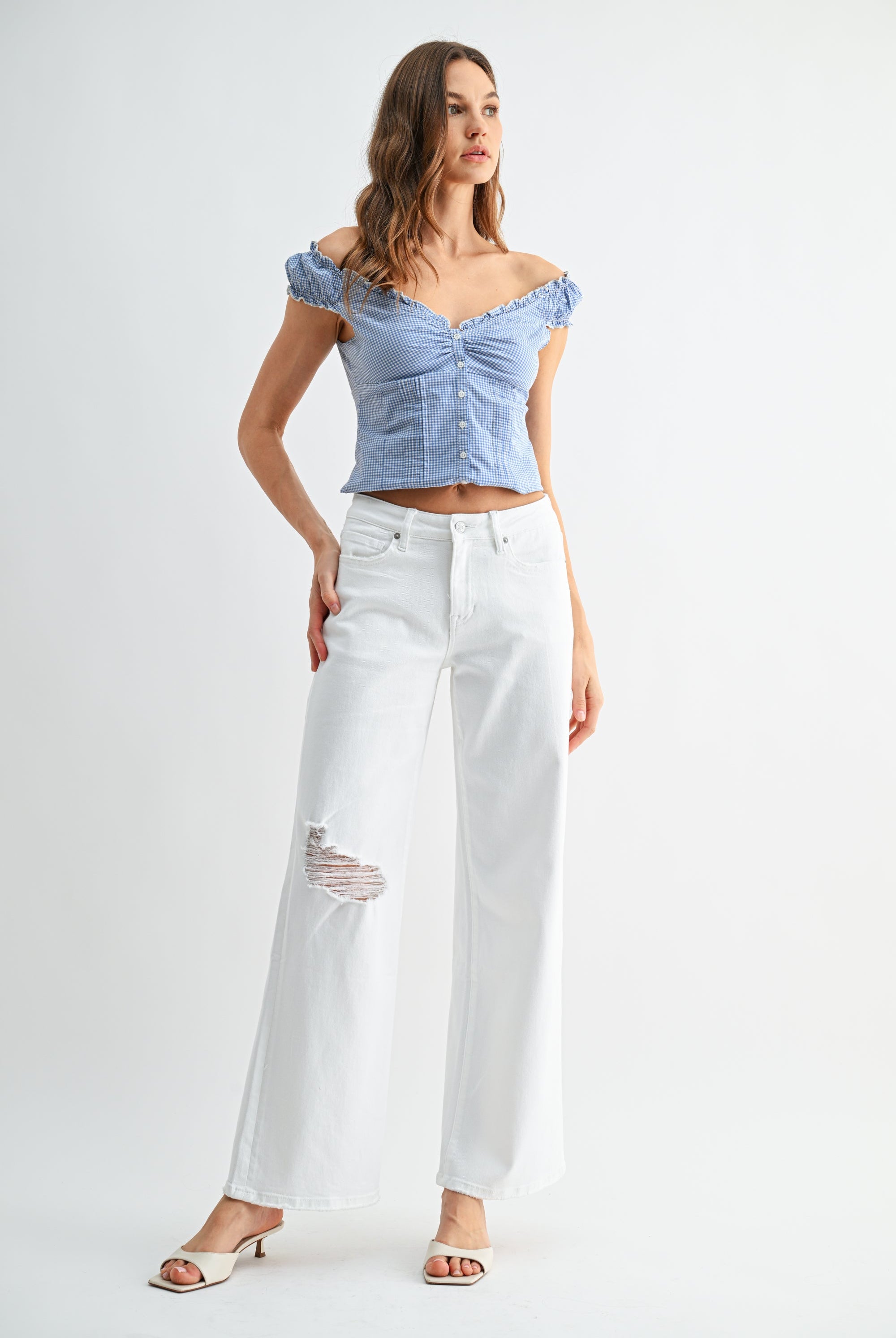 Mid rise distressed wide leg jeans by RARA Boutique, featuring a relaxed fit and ripped details in a light wash.
