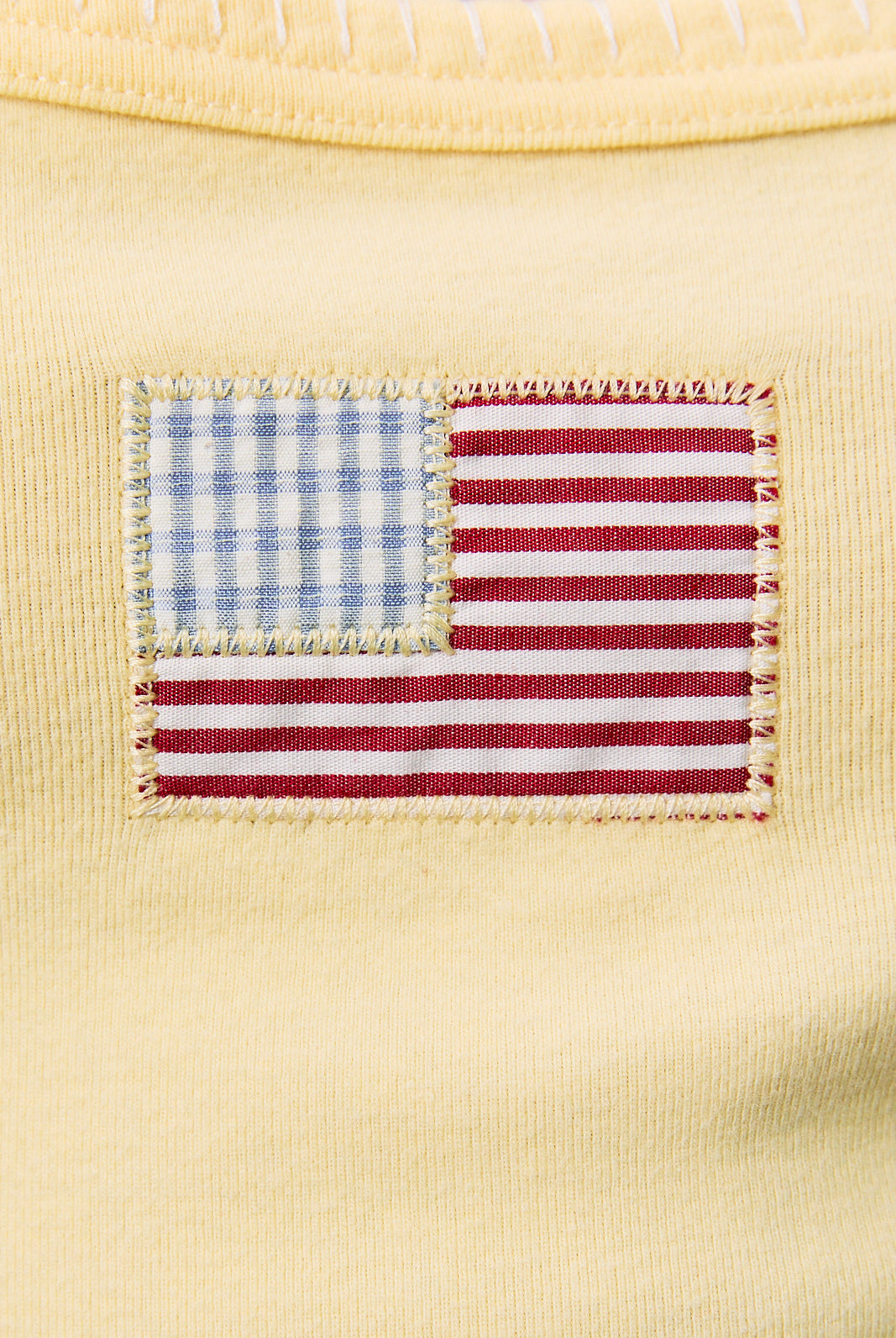 Yellow cropped tank top with American flag patchwork design, contrast trim, by RARA Boutique.