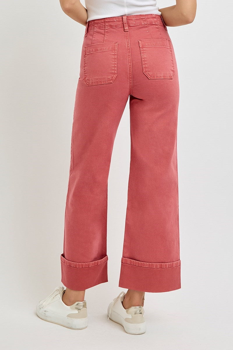 Risen wide leg patch pocket button fly jeans in brick color, featuring relaxed fit and classic denim style.