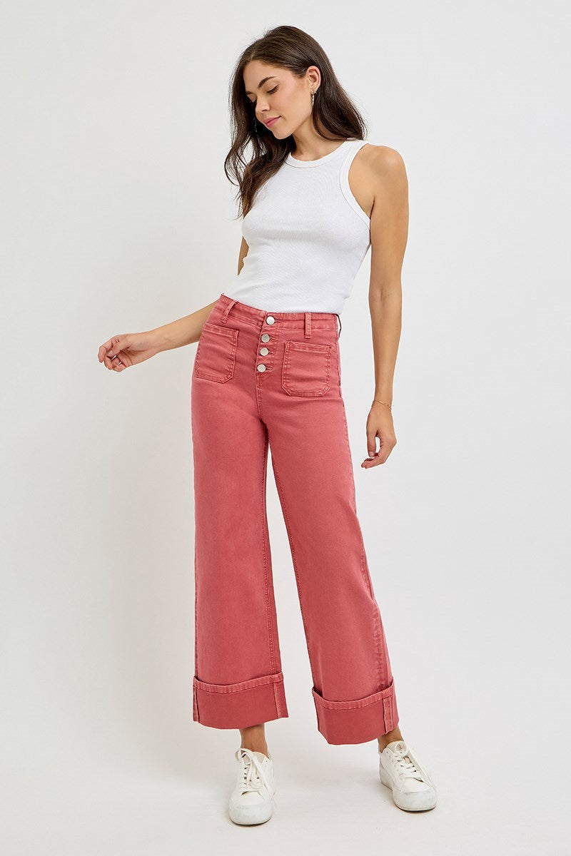 Risen wide leg patch pocket button fly jeans in brick color, featuring relaxed fit and classic denim design.