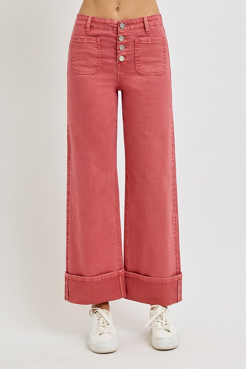 Risen wide leg patch pocket button fly jeans in brick color, featuring relaxed fit and classic denim style.