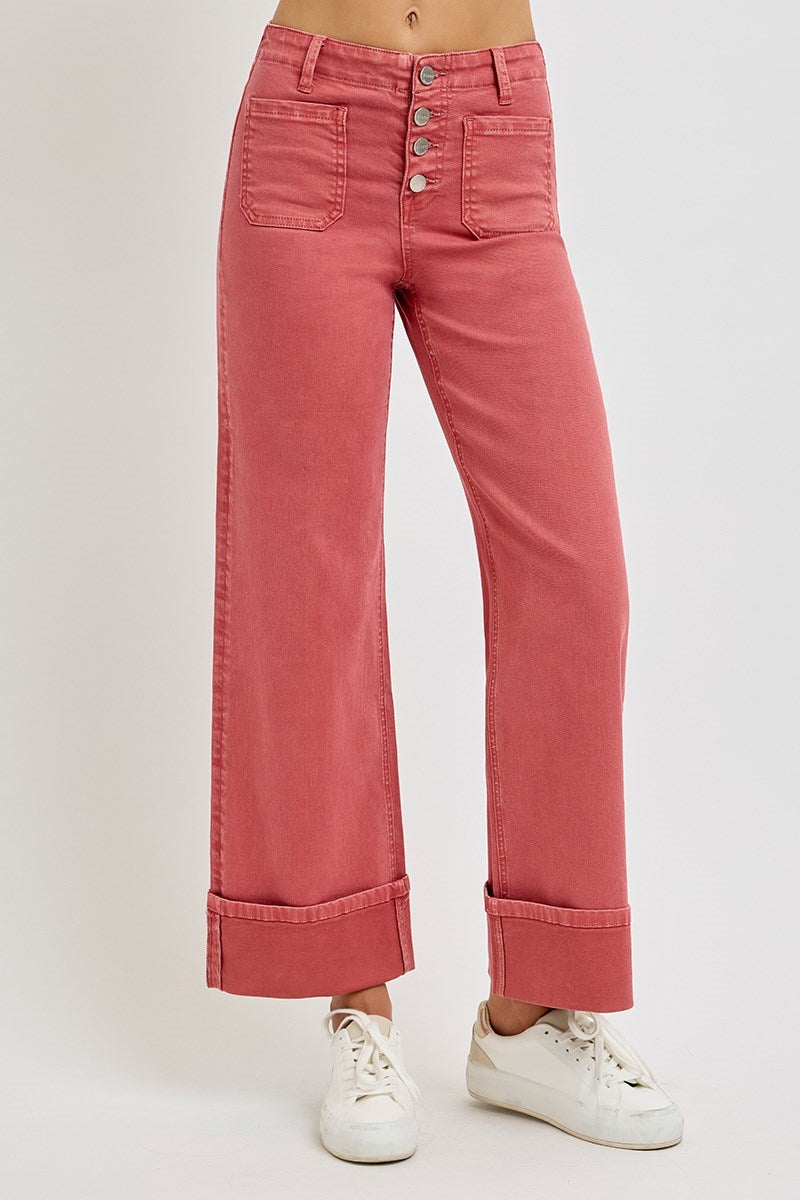 Risen wide leg patch pocket button fly jeans in brick color, showcasing relaxed fit and classic denim style.