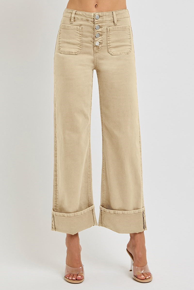Light brown wide-leg Risen jeans with patch pockets and button fly, displayed on a hanger.
