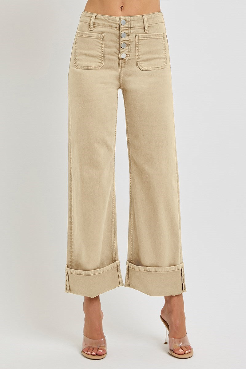 Light brown wide-leg Risen jeans with patch pockets and button fly, displayed on a hanger.