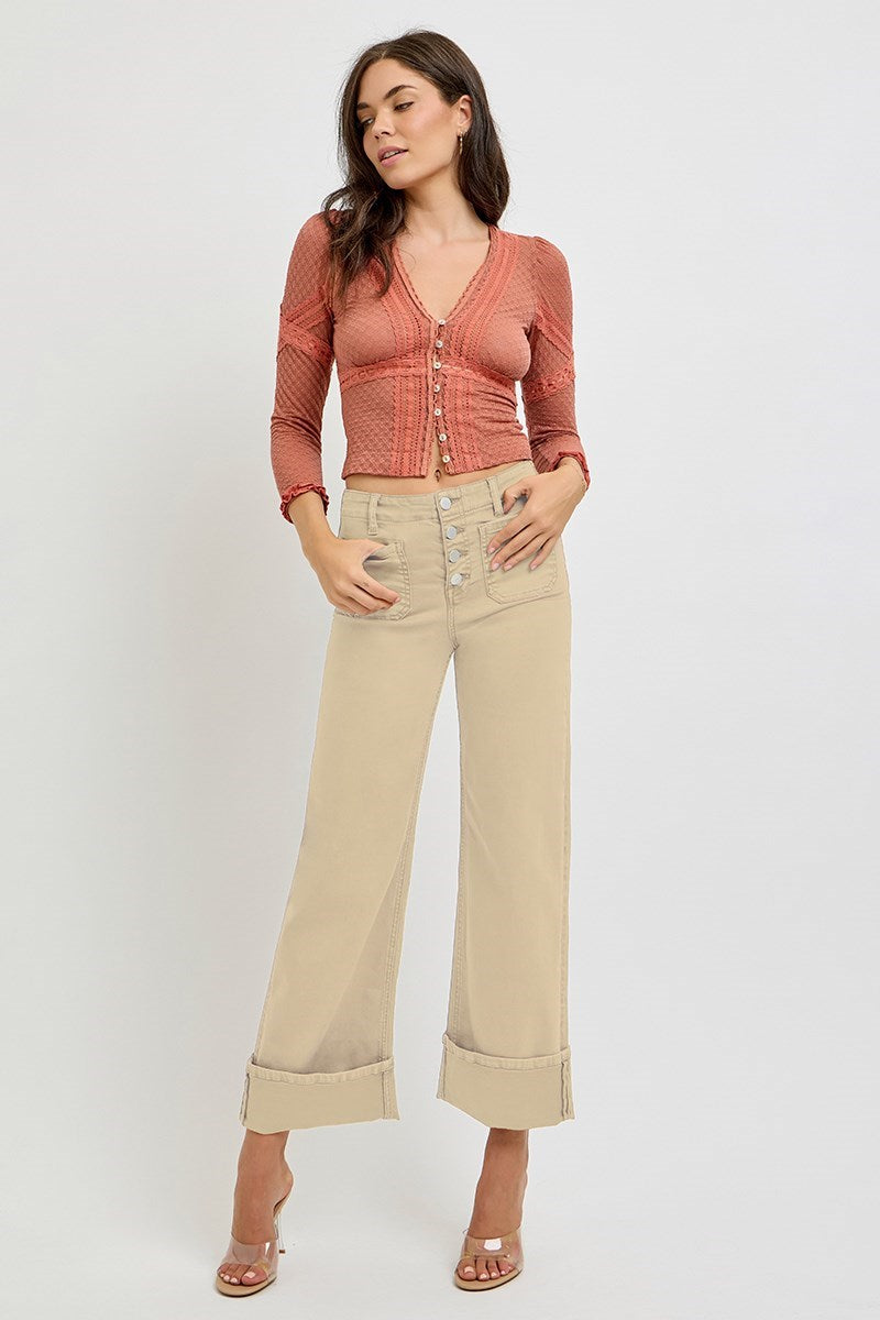 Risen wide leg patch pocket button fly jeans in a latte color, featuring classic denim style and relaxed fit.