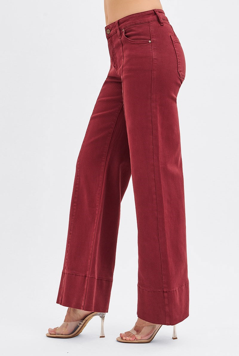 RARA Boutique wine-colored tummy control mid-rise pin tuck wide-leg jeans with wide hem, styled with a natural pose.