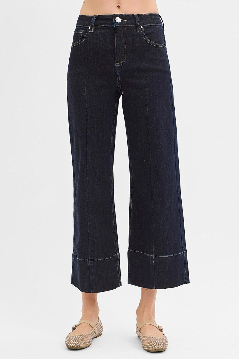 Dark wash pintuck tummy control wide-leg cropped jeans with wide hem by Risen, featuring a stylish and flattering fit.
