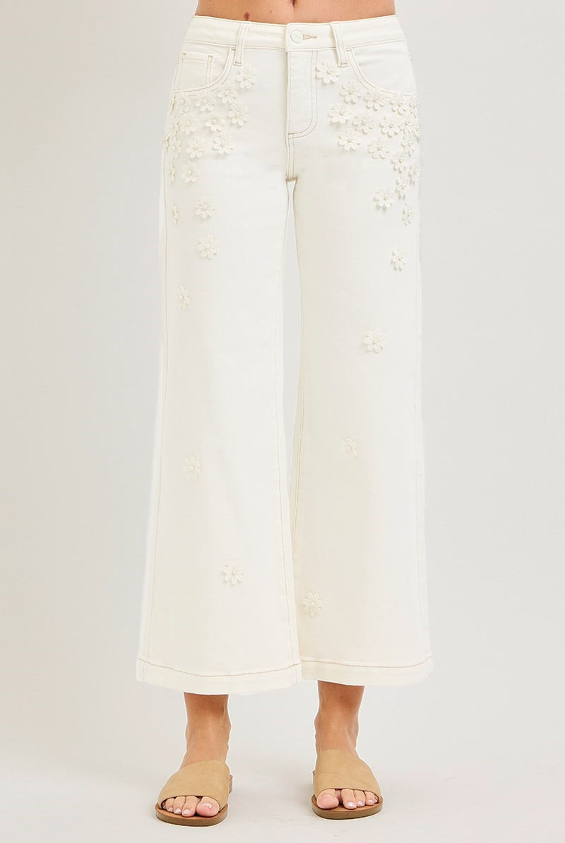 Cream wide-leg cropped jeans by Risen with 3D flower and pearl embellishments, featuring a relaxed fit and stylish details.