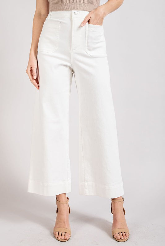 Blue soft wash wide-leg jeans from RARA Boutique paired with a pleated blouse in a stylish lounge set.