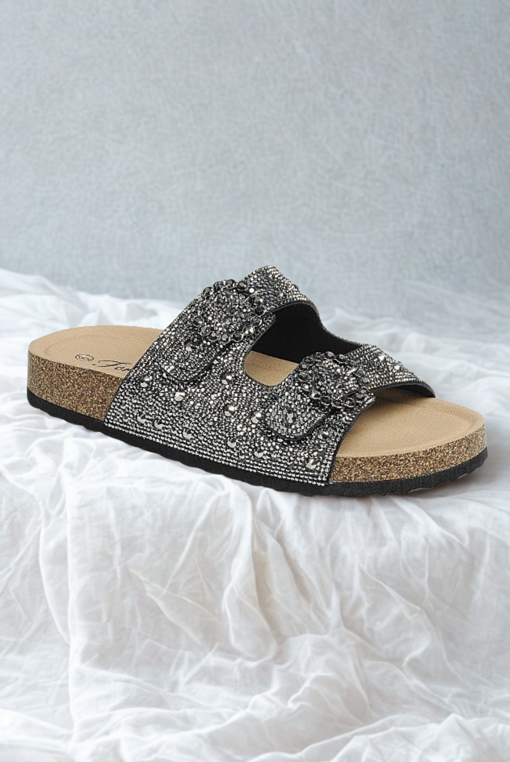 Rara Boutique rhinestone cork sole double buckle slide sandals showing sparkling rhinestones and tan cork footbed with silver buckles.