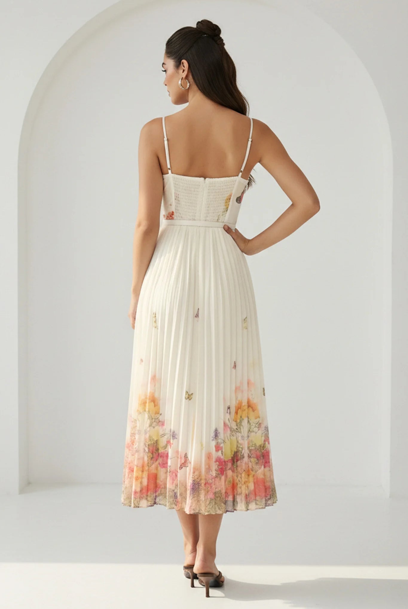 RARA Boutique watercolor floral butterfly pleated midi dress with belt in peach, featuring a flowing design and elegant style.