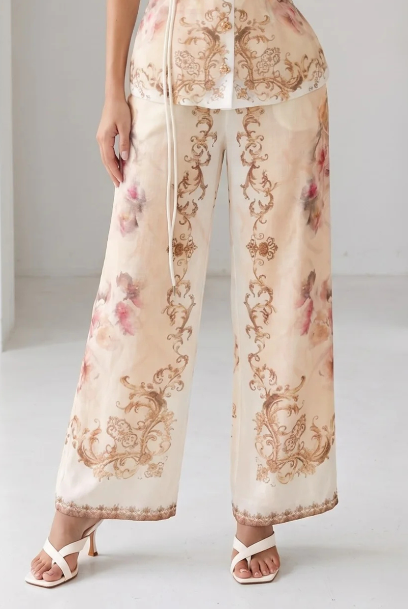 Peach watercolor floral baroque border wide-leg pants from RARA Boutique, with flowing fabric and intricate floral designs.