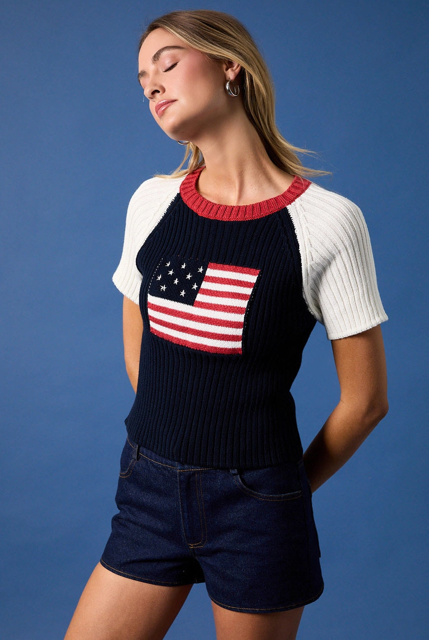 RARA Boutique American flag raglan knit blouse with short sleeves, casual and stylish, featuring patriotic flag imagery on the front.