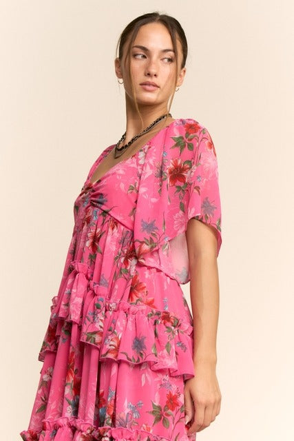 Floral tiered ruffle maxi dress with flutter sleeves by RARA Boutique, showcasing a flowy, feminine design with vibrant floral patterns.