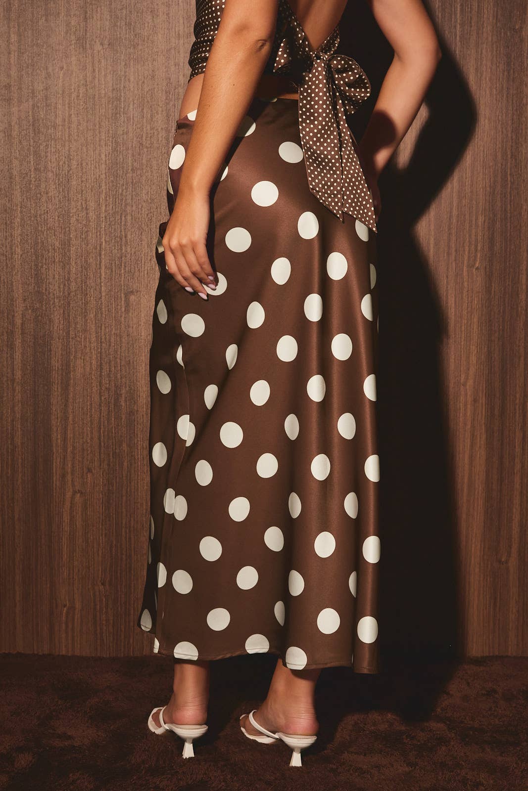 Mid-wisted polka dot bias skirt from LE LIS, featuring a flowing silhouette and classic black and white dot pattern.