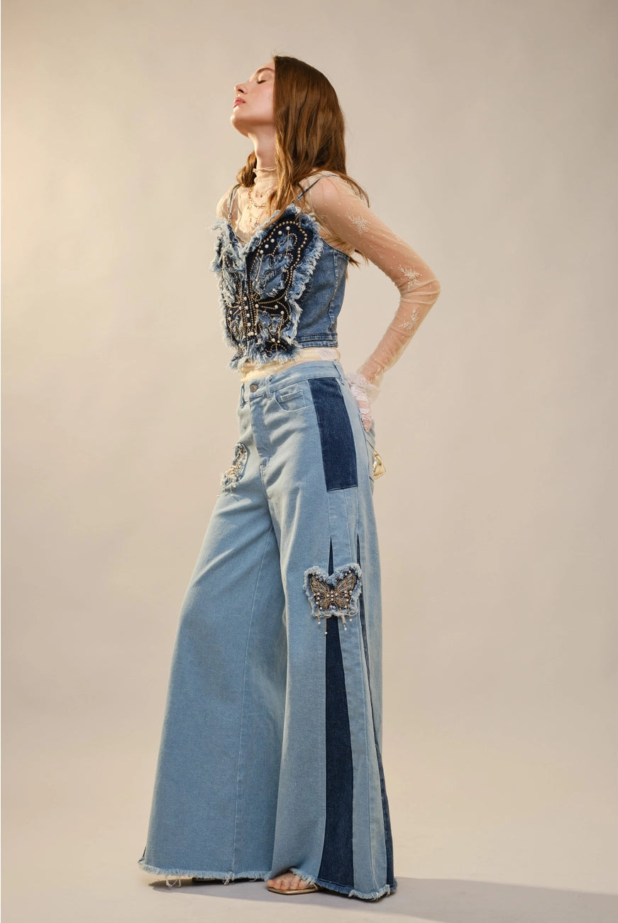 Blue denim corset top with butterfly embellishments, stylish blouse by RARA Boutique, featuring detailed butterfly decorations.