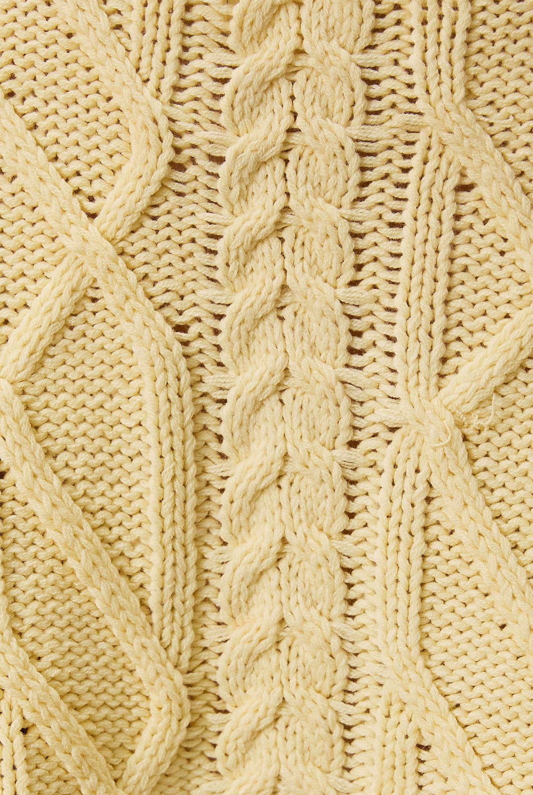 LE LIS oversized cropped cable knit sweater featuring chunky knit cable pattern and a relaxed, cropped fit in soft fabric.