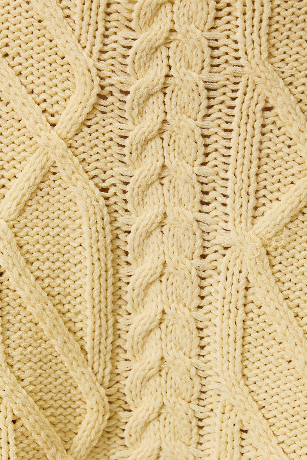 LE LIS oversized cropped cable knit sweater featuring chunky knit cable pattern and a relaxed, cropped fit in soft fabric.