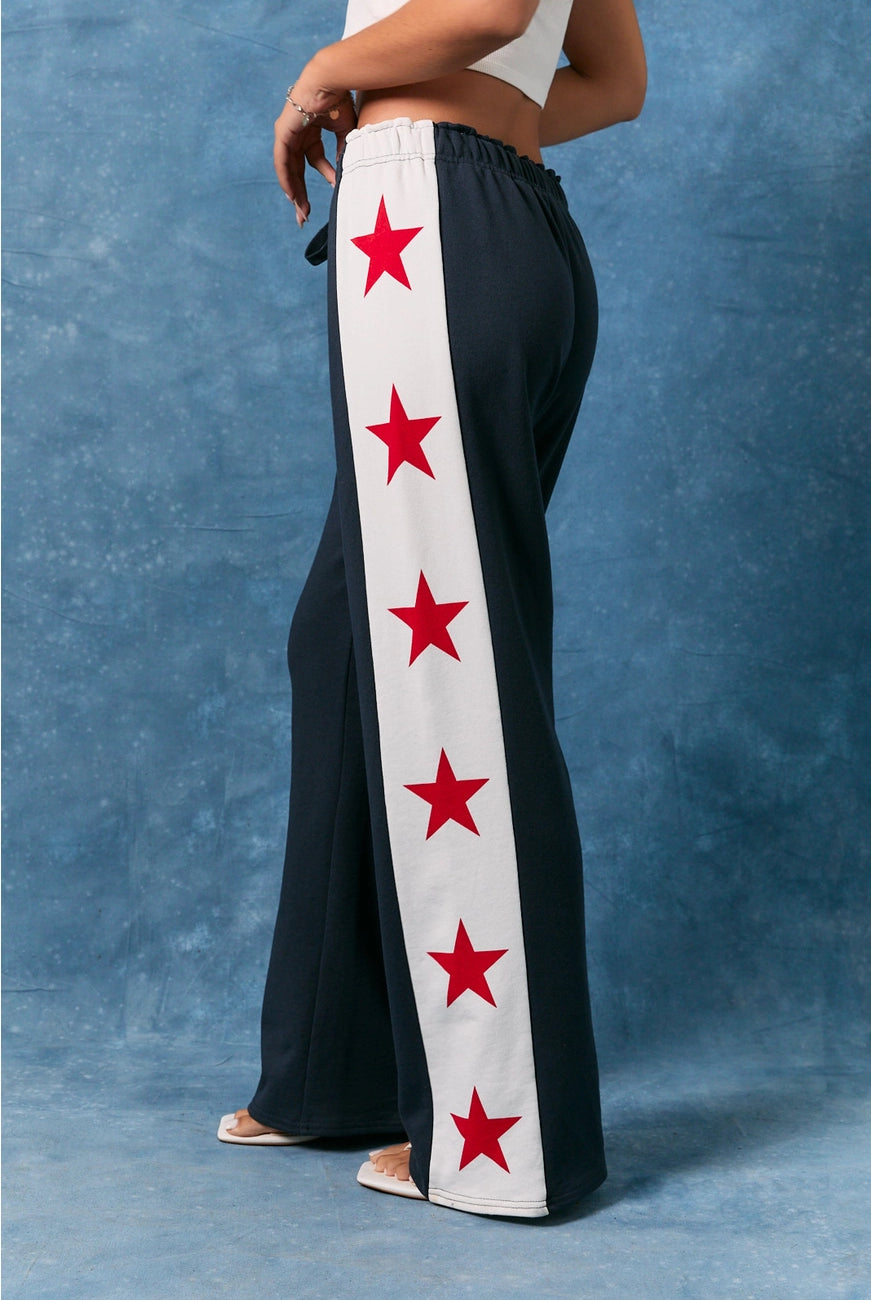 RARA Boutique star side stripe wide leg baggy sweatpants with relaxed fit and bold star side details, shown on a hanger.