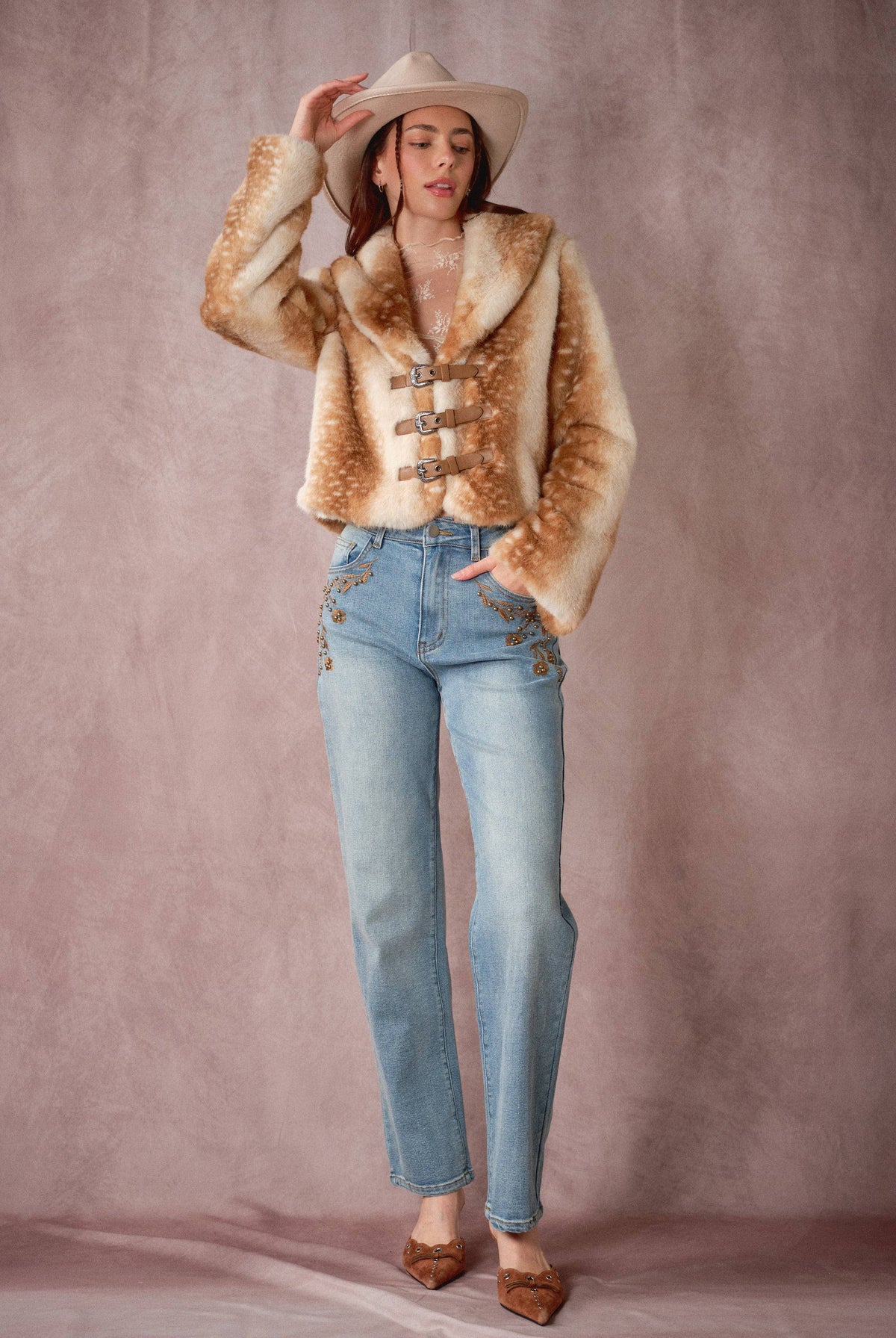 Blue B 25004J buckled faux fur jacket with deer print and buckle details, showcasing its stylish design and soft texture.