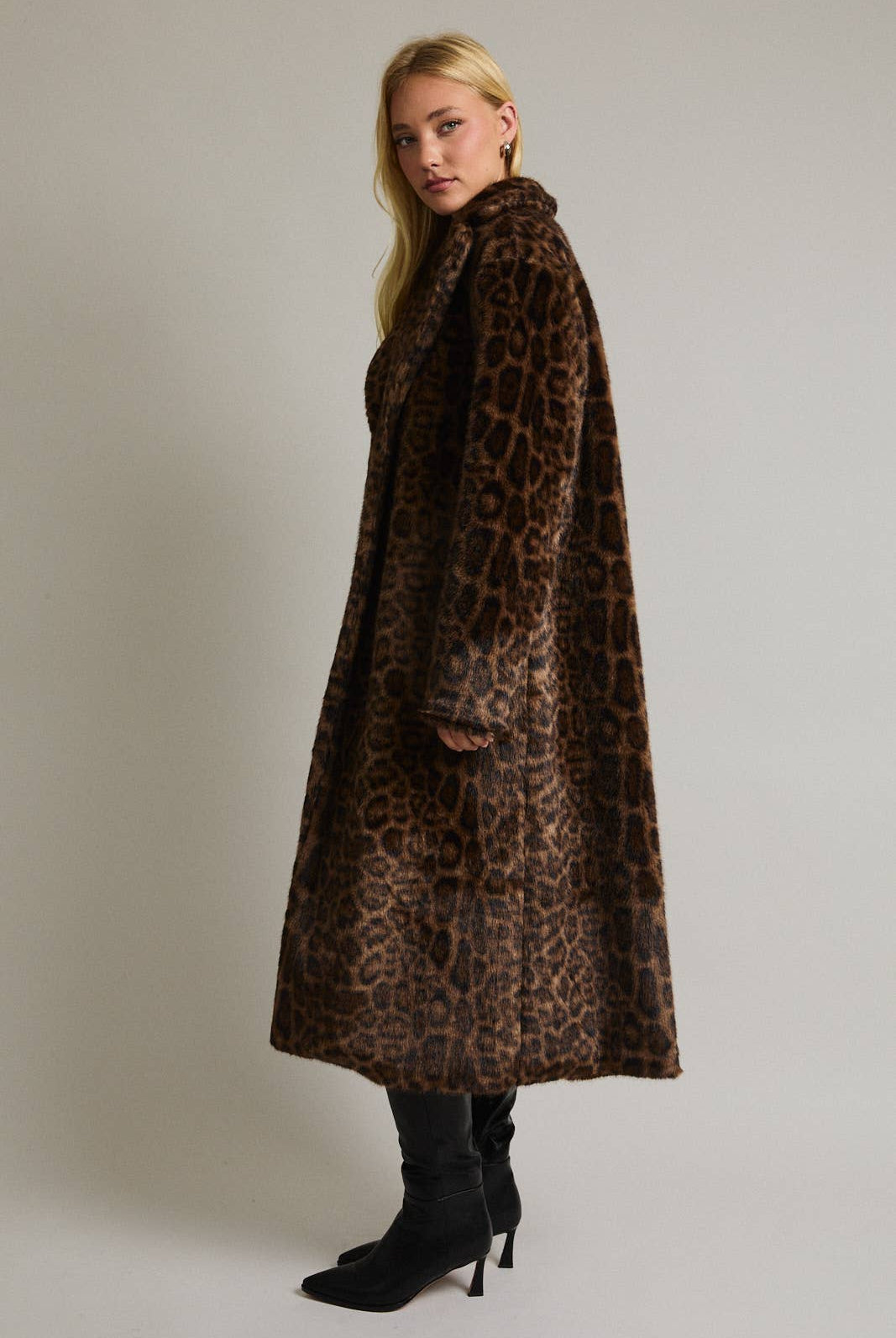 Le Lis faux fur long coat jacket with plush, textured fur in a stylish, warm design, displayed on a hanger.