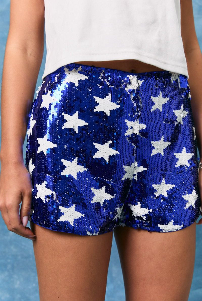 Blue and white sequin star mid-rise shorts from Le Lis by RARA Boutique, featuring sparkly star embellishments.