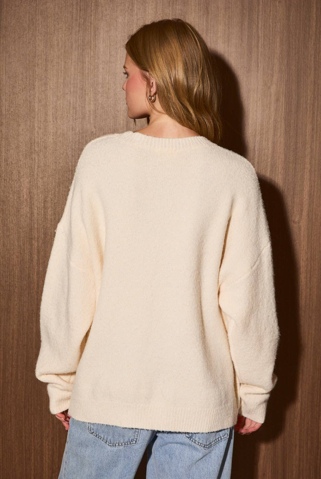 LE LIS embroidery detail sweater top with intricate stitching and soft knit fabric, styled on a mannequin.