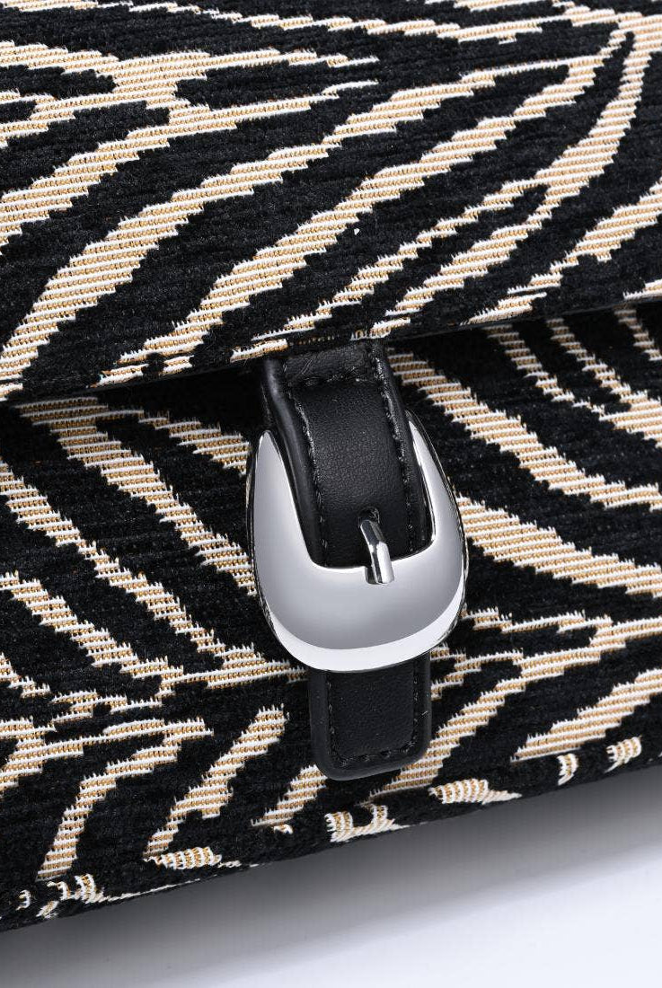 Urban Expressions Tuesday Gloria zebra shoulder bag with adjustable strap and stylish black and white zebra print.