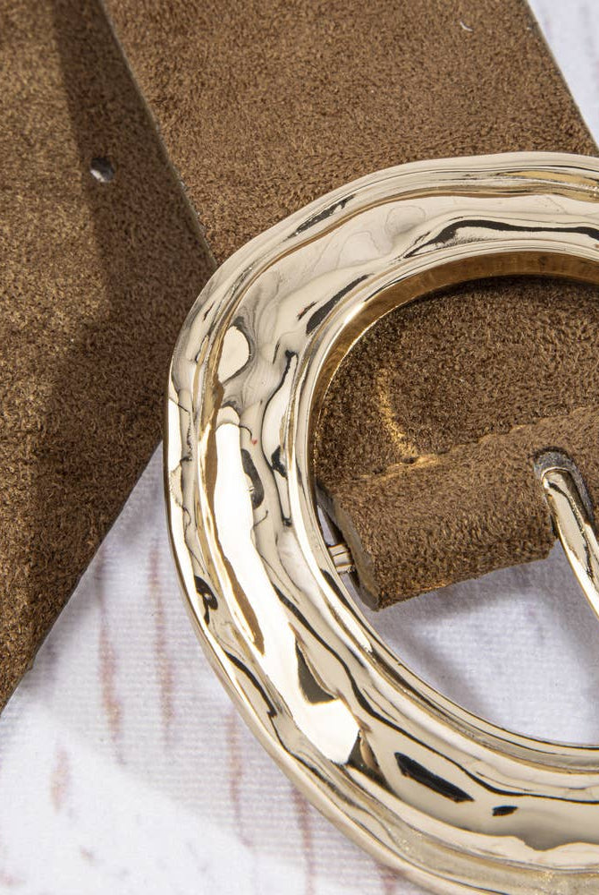 Suede hammered round buckle belt by Collections by Fame Accessories showing a close-up of the textured suede strap and round metal buckle.