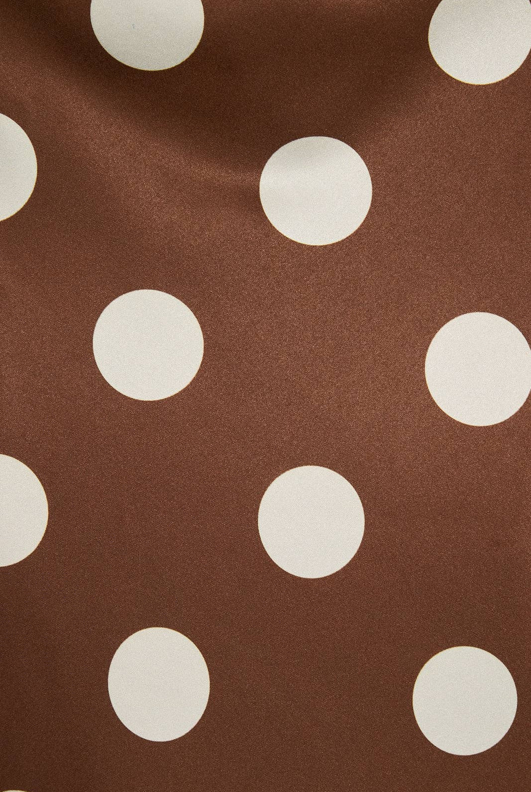 Mid-wisted polka dot bias skirt by LE LIS, featuring a flowing fabric with a classic black and white dotted pattern.