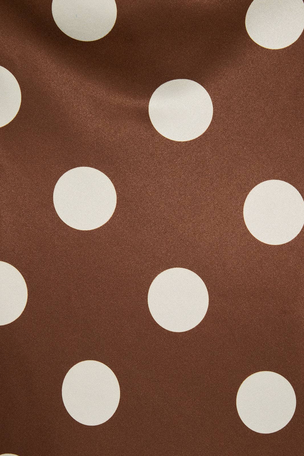 Mid-wisted polka dot bias skirt by LE LIS, featuring a flowing fabric with a classic black and white dotted pattern.
