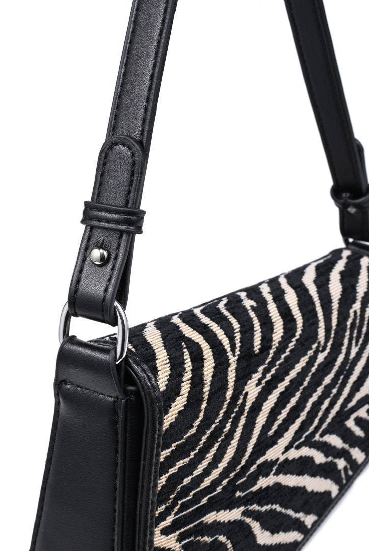 Urban Expressions Tuesday Fatima zebra shoulder bag with black leather strap and textured zebra print fabric.