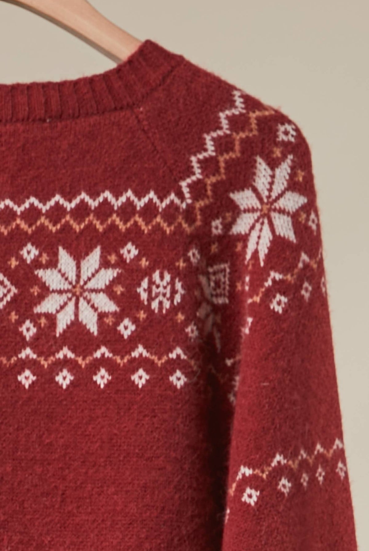 Reindeer Fair Isle knit cardigan by Mello featuring festive reindeer and snowflake patterns in cozy wool blend.