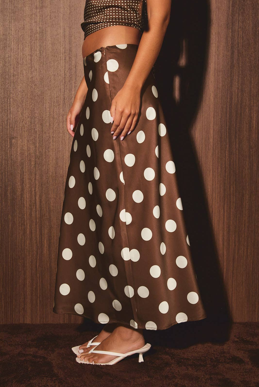 Mid-waisted polka dot bias skirt by LE LIS, showcasing a flowy design with a classic black and white polka dot pattern.