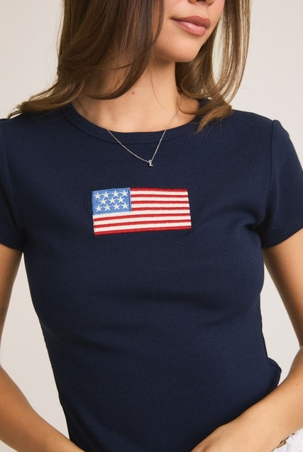 Rara Boutique embroidered American flag ribbed baby tee, soft cotton T-shirt with patriotic flag design for infants.