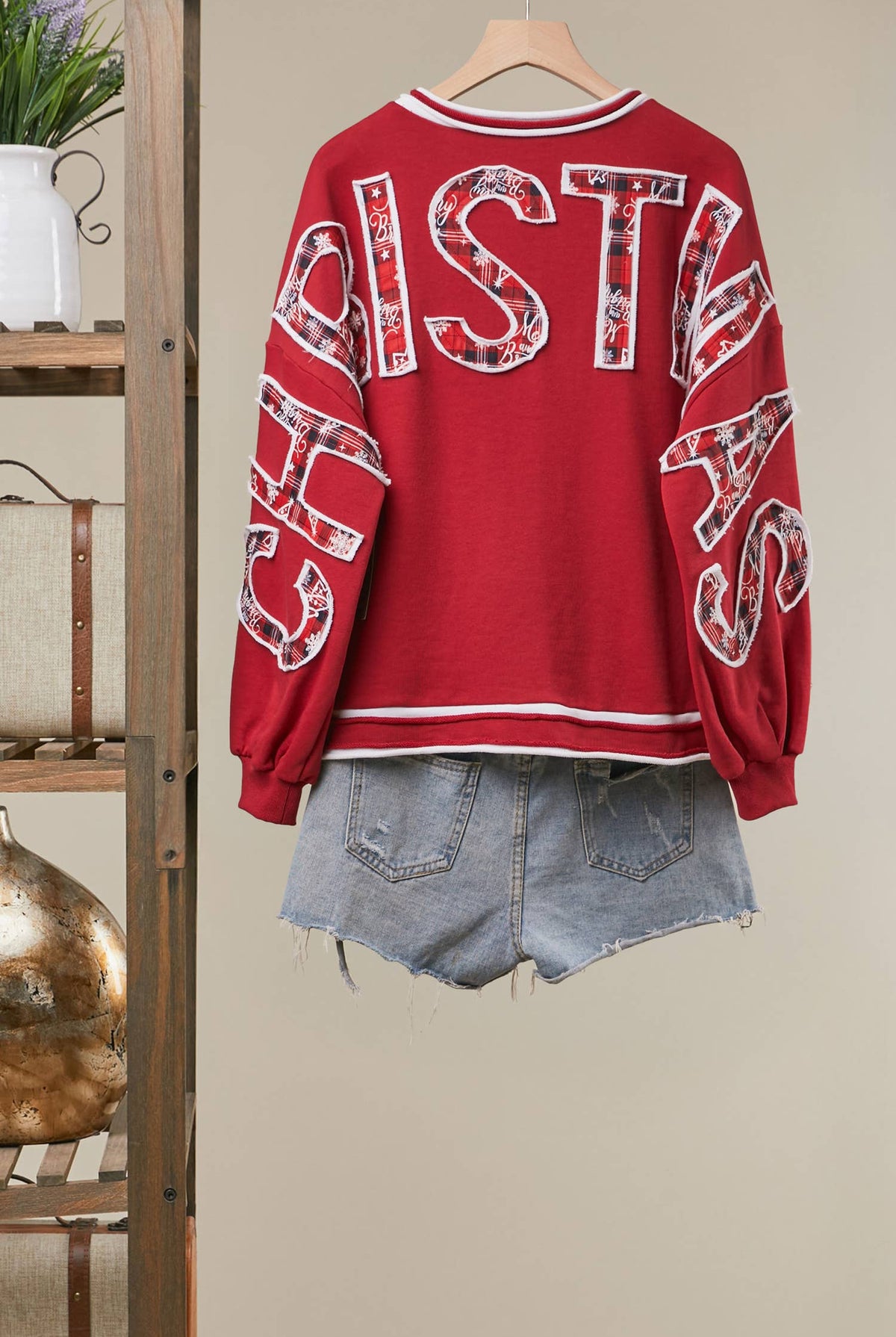 Mello Tuesday Holiday Merry Christmas letter sweatshirt featuring festive red and white design, cozy knit fabric, and holiday lettering.