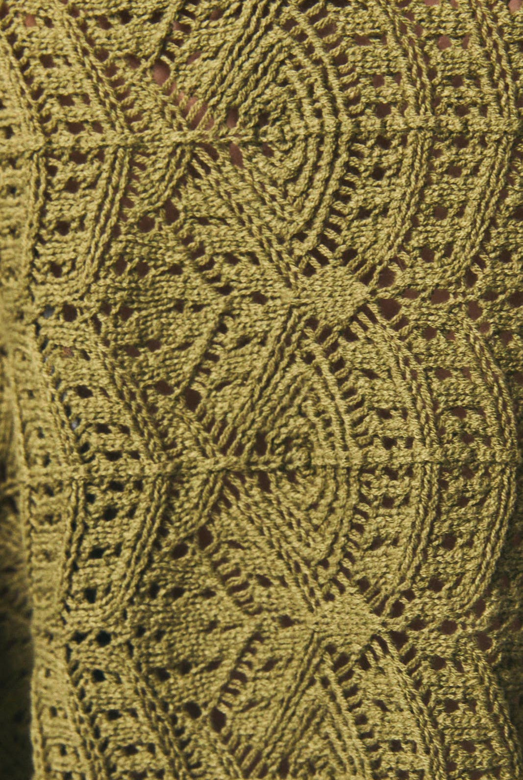 Long sleeve crochet cardigan by LE LIS featuring intricate knit patterns and a relaxed fit, displayed on a neutral background.