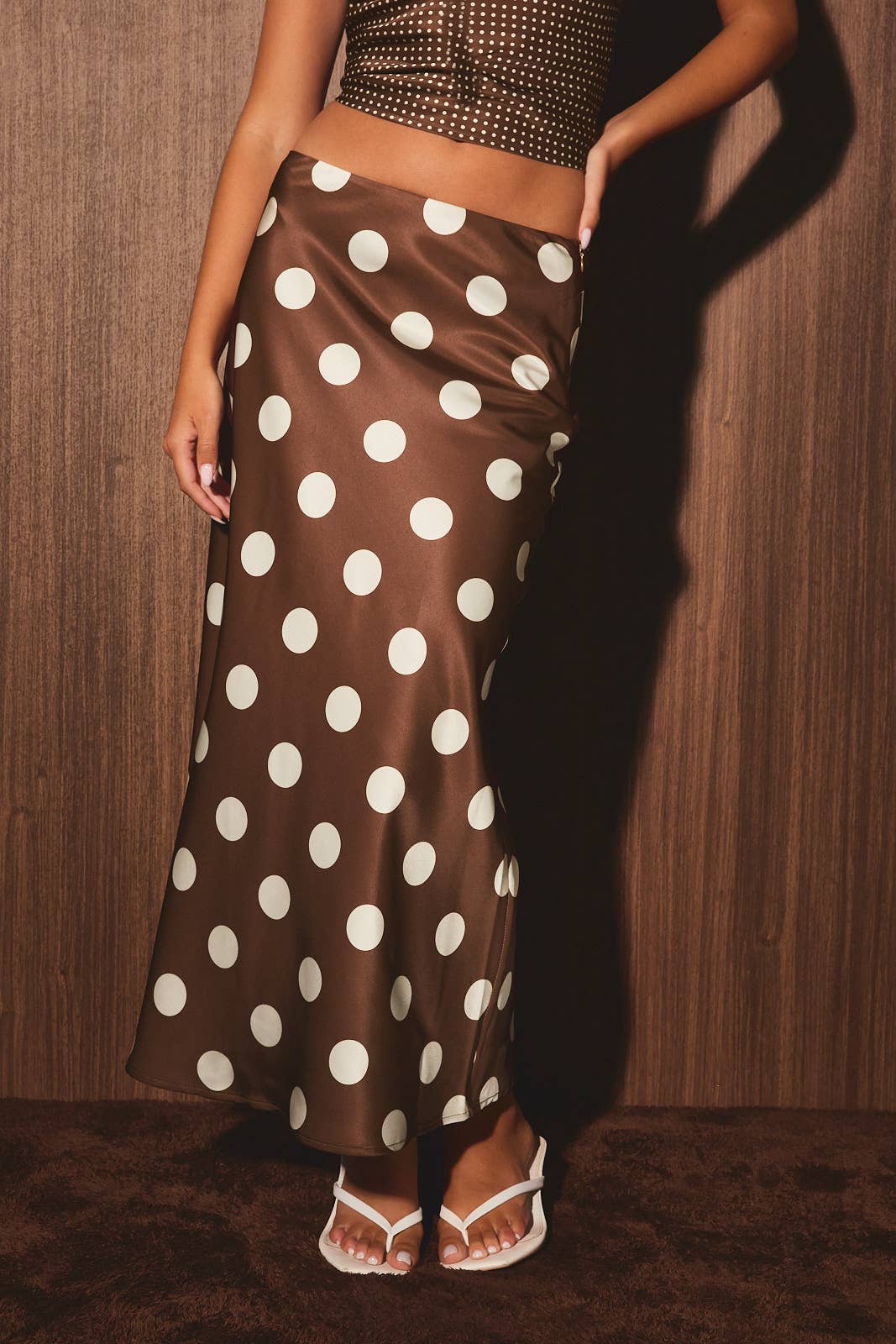Mid-waisted polka dot bias skirt by LE LIS, featuring a flowing design with a classic pattern and feminine silhouette.